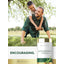A man plays with a boy on his back in a grassy park, next to an Asparagus extract bottle.