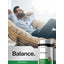 Adult man relaxes in a rattan chair with eyes closed, holding a Horbäach Scullcap supplement bottle.