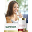 Young woman smiling while holding a water glass next to a Tart Cherry & Celery Seed supplement bottle.