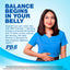A smiling young woman looks up while holding her stomach, alongside a bottle of PB8 Probiotic.