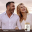 A middle-aged man and woman smiling while looking away, next to a bottle of Black Garlic.