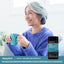 A senior woman smiles while holding a mug next to a Bloat + Metabolism Probiotic bottle.