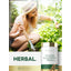Lifestyle image of woman gardening with Carlyle Yellow Dock Root 1500 mg bottle and graphic stating HERBAL.
