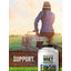 A person in a jacket and hat sits on a wooden fence next to a bottle of Carlyle Grass Fed Whey.