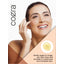 Lifestyle image of adult touching her face with Coera Vitamin E Oil, with text stating Gently apply to rough, dry skin, lines and wrinkles to moisturize and revitalize skin.