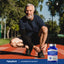 Elderly man tying his shoe on a running track next to a Chondroitin Sulfate bottle.