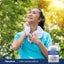 A woman cooling down after exercising outside with a Coral Calcium Complex bottle nearby.