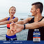 A young man and woman stretch outdoors by the water with a Hyaluronic Acid bottle visible nearby.