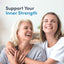 An older and a younger woman are embracing and laughing together joyfully.