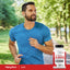 A man in his 30s jogging outside while holding a Max Strength AAKG bottle.
