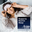 Young woman smiling in bed, removing a sleep mask, with an overlay for Natural Vitality MaxCalm Sleep.