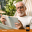 Lifestyle image of an adult reading in a hammock with Piping Rock Vitamin B12 bottle nearby