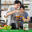 Adult pouring orange smoothie into a glass in a kitchen with Piping Rock Super Fruits & Veggies supplement bottle nearby