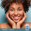 Adult smiling with hands resting against the face, with a Piping Rock Grass-Fed Peptides Collagen + C Types I & III 6000 mg bottle shown in the lower right corner.