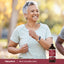Adult smiling while walking outdoors, with a Piping Rock Multi Collagen Liquid bottle nearby