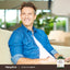 Lifestyle image of smiling man seated on a couch with Piping Rock Odorless Garlic bottle nearby.