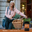 Lifestyle image of smiling woman with bicycle and Piping Rock Turmeric Curcumin 500mg supplement bottle nearby.
