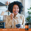 Lifestyle image of adult eating blueberries with Piping Rock Prebiotic Fiber bottle nearby, graphic stating SOLUBLE + INSOLUBLE FIBER.