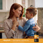 A smiling woman holds a young boy with a bottle of Kids Probiotic Chewables in view.