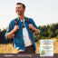 A middle-aged man enjoying a hike in nature, carrying a tub of Pine Pollen Powder.