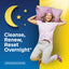 Young woman in pajamas joyfully jumps with pillow, next to graphic text 'Cleanse, Renew, Reset Overnight' for CleanseMore.
