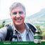 Senior man hiking outdoors, smiling next to a Triple Magnesium Complex bottle.