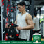 Young adult male exercising with a 20 KG weight plate in a gym, next to a tub of WheyFit Isolate protein.